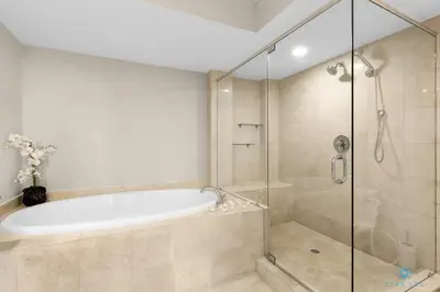 a bathroom with a tub and a glass shower at Amazing View Beachfront Resort Luxury Amenities in Hallandale Beach