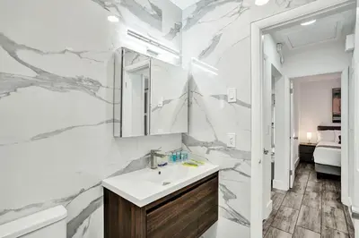 a white bathroom with a sink and a mirror at Seaside Oasis in Hollywood Lakes near the Beach in Hollywood