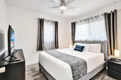 a bedroom with a bed and a flat screen tv at Seaside Oasis in Hollywood Lakes near the Beach in Hollywood