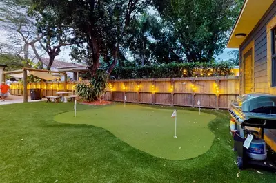 a yard with a putting green with miniature golf balls at Walking On Sunshine in Fort Lauderdale