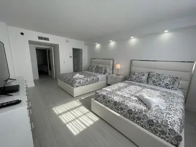a bedroom with two beds and a television in it at Amazing Ocean View! 10 floor Parking included in Sunny Isles Beach