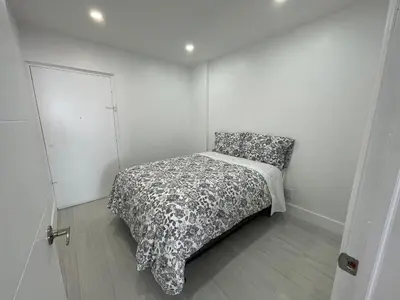 a bedroom with a bed with a black and white comforter at Amazing Ocean View! 10 floor Parking included in Sunny Isles Beach