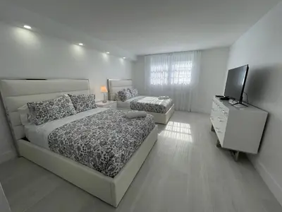 a bedroom with two beds and a television in it at Amazing Ocean View! 10 floor Parking included in Sunny Isles Beach