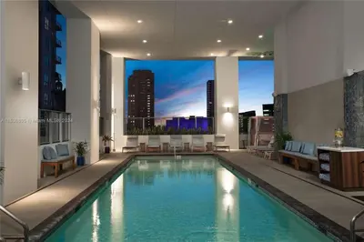 a swimming pool in a building with a view of a city at Ocean View Designer Studio, Pool in Miami