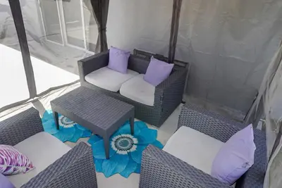 a gazebo with chairs and purple pillows at Miami Luxury Home Rental in Miami