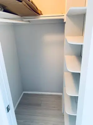 an empty closet with white shelves and a door at MODERN 2BR 2BA CONDO near AVENTURA! Wi-Fi! Parking in North Miami Beach
