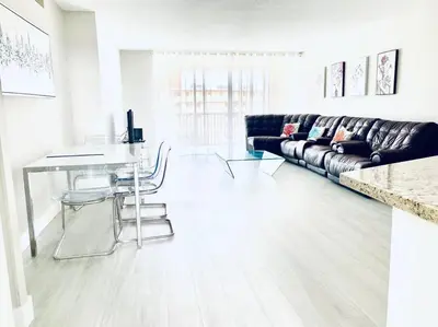 a living room with a couch and a table at MODERN 2BR 2BA CONDO near AVENTURA! Wi-Fi! Parking in North Miami Beach
