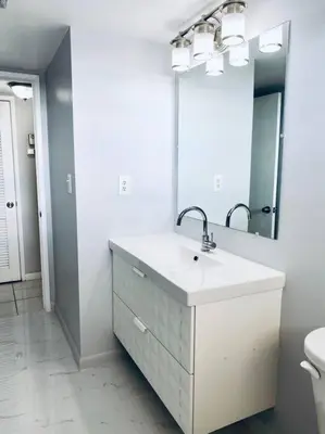 a white bathroom with a sink and a mirror at MODERN 2BR 2BA CONDO near AVENTURA! Wi-Fi! Parking in North Miami Beach
