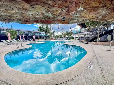 a swimming pool with blue water in a building at AK414- Miami Beach Apt at Oceanfront Resort in Miami Beach