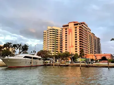 a boat docked at a marina with tall buildings at AK414- Miami Beach Apt at Oceanfront Resort in Miami Beach
