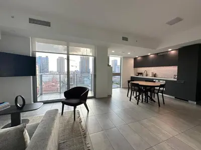 a living room with a couch and a table with chairs at Apartamento en Downtown Miami in Miami