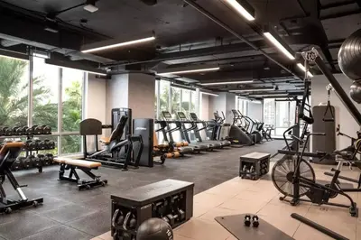 a gym with a bunch of tread machines and a bike at Apartamento en Downtown Miami in Miami