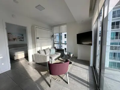 a living room with a couch and a bed in a building at Apartamento en Downtown Miami in Miami
