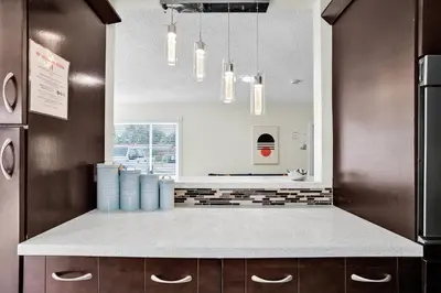 a kitchen with a counter with blue bottles on it at Hollywood Villa Luxury & Private Pool in Hollywood