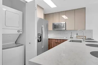 a white kitchen with a refrigerator and a sink at Biscayne Park Villas 15400 in Miami