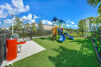 a playground with a slide in a park at Hard Rock Stadium Home Base! Luxe Condo with Pool in Joe Robbie Stadium Heliport