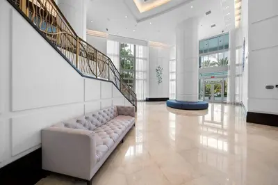a living room with a couch and a staircase at FontaineBleau Resort, with Balcony 10 min from SoBe in Miami Beach