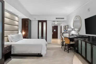 a hotel room with a bed and a desk at FontaineBleau Resort, with Balcony 10 min from SoBe in Miami Beach