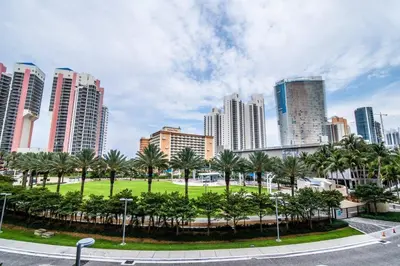 a park in a city with palm trees and buildings at Beautiful holiday apartment in Ocean Recerve near beach in Sunny Isles Beach