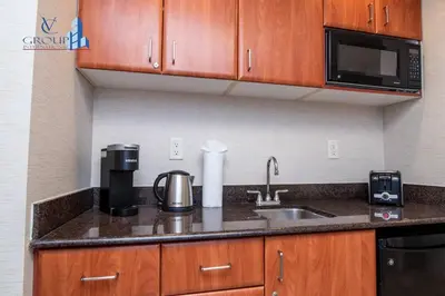 a kitchen with a sink and a microwave at Luxurious beachfront studio in Sunny Isles Beach