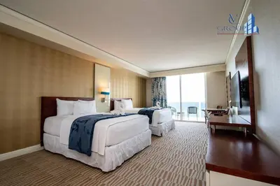a hotel room with two beds and a balcony at Luxurious beachfront studio in Sunny Isles Beach