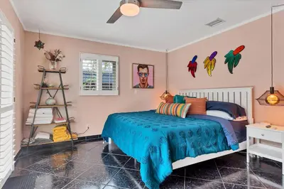 a bedroom with a bed with a blue blanket at 5 Minute Walk to Wilton Drive in Fort Lauderdale