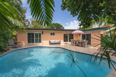 a swimming pool in front of a house at 5 Minute Walk to Wilton Drive in Fort Lauderdale