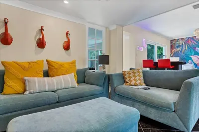 a living room with two blue couches and a table at 5 Minute Walk to Wilton Drive in Fort Lauderdale
