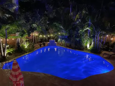 a large blue swimming pool at night at 5 Minute Walk to Wilton Drive in Fort Lauderdale