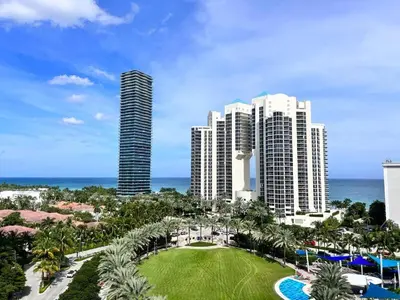 a view of a resort with tall buildings and a park at Nice and economic family apartment on the beach in Sunny Isles Beach