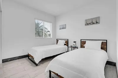 two beds in a room with white walls at Biscayne Park Villas 15408 in Miami