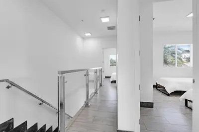 a room with white walls and a corridor with beds at Biscayne Park Villas 15408 in Miami
