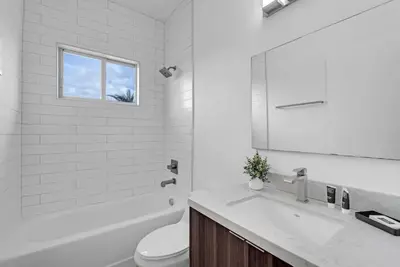 a white bathroom with a sink and a toilet at Biscayne Park Villas 15408 in Miami