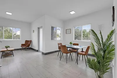 a dining room with a table and chairs and a plant at Biscayne Park Villas 15408 in Miami
