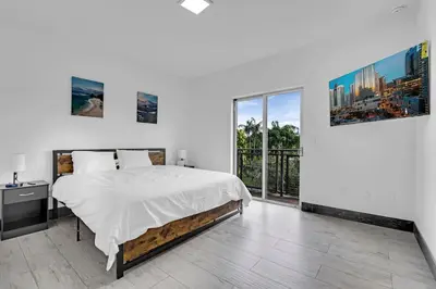 a bedroom with a bed and a large window at Biscayne Park Villas 15408 in Miami