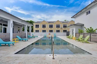 a swimming pool in front of a building at Biscayne Park Villas 15440 in Miami