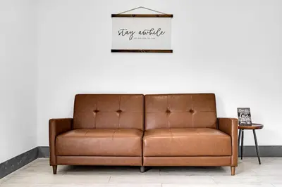 a brown leather couch sitting in a living room at Biscayne Park Villas 15440 in Miami