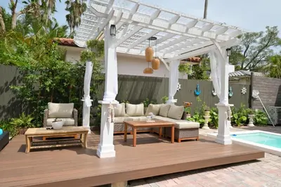 a white pergola with a couch and a table at D' Mauchi Waterfront House in Miami