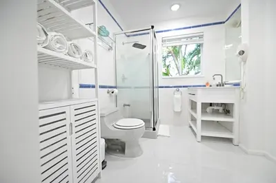 a white bathroom with a toilet and a sink at D' Mauchi Waterfront House in Miami