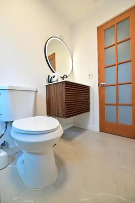 a bathroom with a white toilet and a mirror at D' Mauchi Waterfront House in Miami
