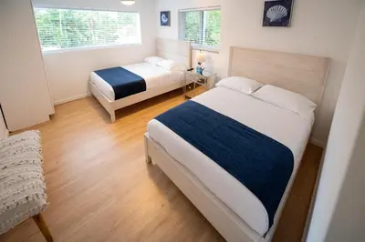 a bedroom with two beds and a window at D' Mauchi Waterfront House in Miami