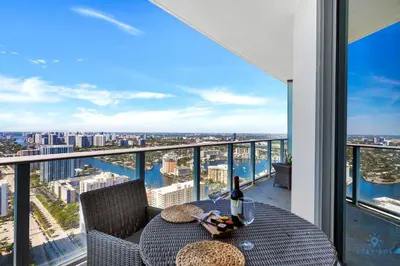 a balcony with a table with a view of the city at Hollywood Beachfront Apt Amazing View & Amenities in Hollywood