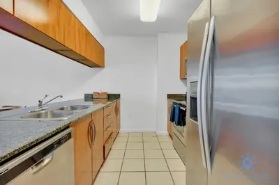 a kitchen with a stainless steel refrigerator at Confortable Apartment with pool and gym in Miami