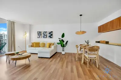 a living room with a white couch and a table at Confortable Apartment with pool and gym in Miami