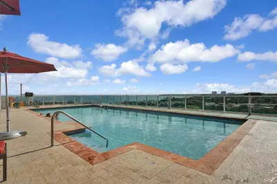a large swimming pool on top of a building at Astonishing SEA VIEW Studio in Grove in Miami