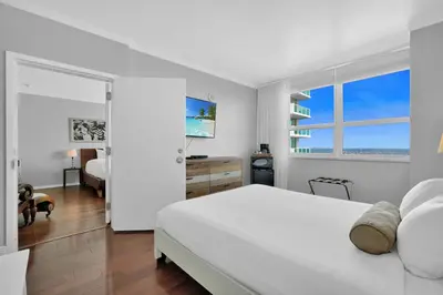 a white bedroom with a white bed and a window at Tropical Paradise Spacious 3 bedroom in Miami