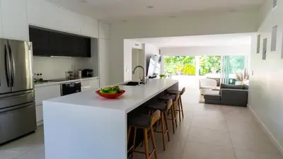 a kitchen with a counter with a bowl of fruit on it at Villa Viscayne - Miami Modern Luxury with Pool & Spa in Biscayne Park