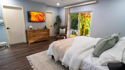 a bedroom with a bed and a dresser and a window at Villa Tropical - Your private Miami Resort with a heated pool in North Miami
