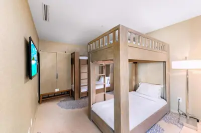 a bedroom with two bunk beds and a flat screen tv at 3MM Oceanfront Residence at Finest Bal Harbour Resort - Hotel Amenities in Miami Beach