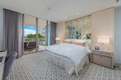 a bedroom with a large bed and a balcony at 3MM Oceanfront Residence at Finest Bal Harbour Resort - Hotel Amenities in Miami Beach